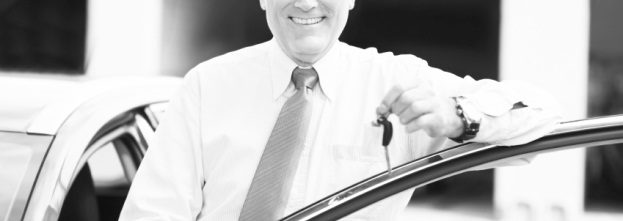 A man with keys to a new car
