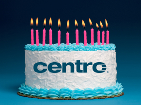 Birthday cake with Centro logo printed on the side with pink candles