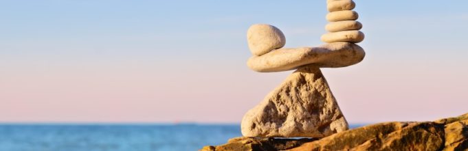 Stones balancing upon one another on a rocky beach coast