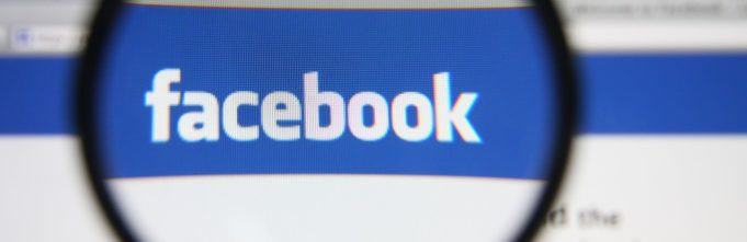 Magnifying glass over the Facebook