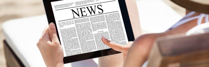 Woman reading news on tablet