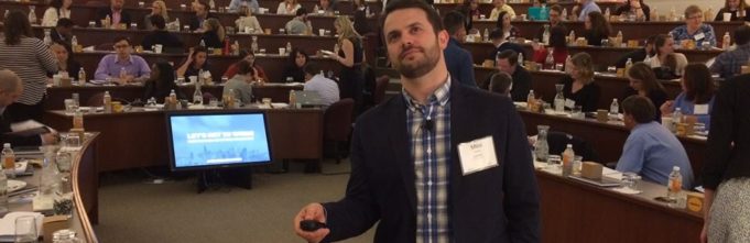 Man standing in center of conference thinking