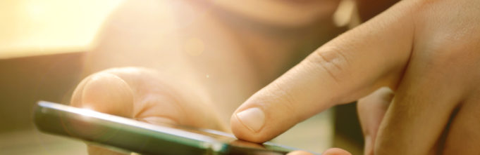Person placing finger on touchscreen phone