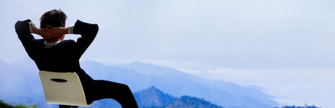 Man sitting in office chair in nature