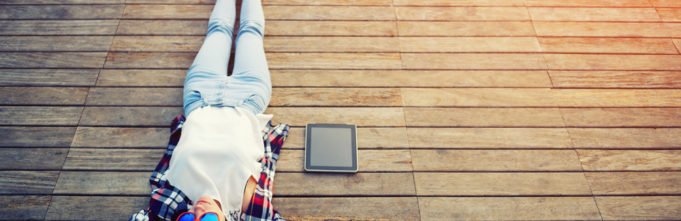 Person hanging out on dock with tablet