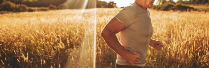 Older gentleman running through a wheat field