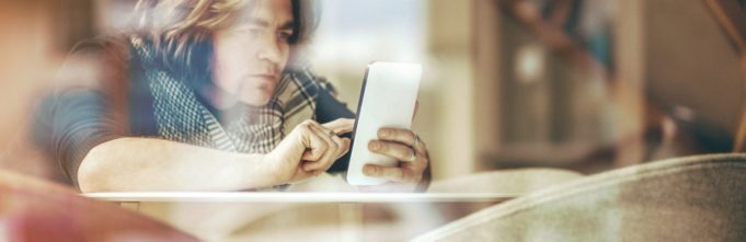 Person looking at mobile phone in scarf