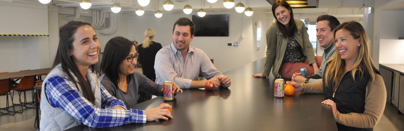 Team of Centrons standing around a table in the kitchen