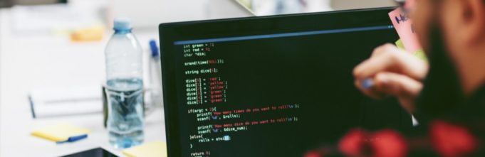 male developer staring at computer screen with code on it