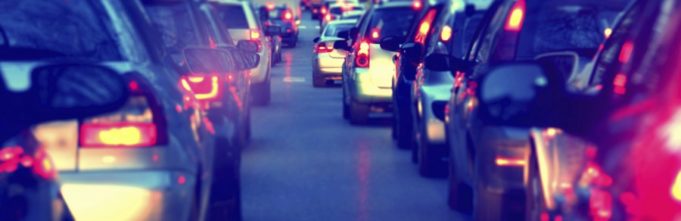 Cars in city traffic on a dark evening