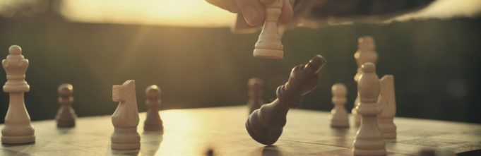 Someone playing chess on a chessboard