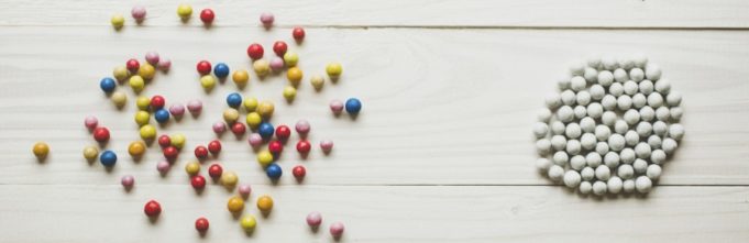 Chaotic colorful balls and organized white balls. Concept of order and chaos