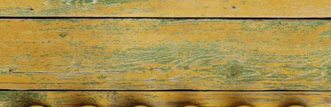 Photos of rubber duckies sitting in a row on a wooden table.
