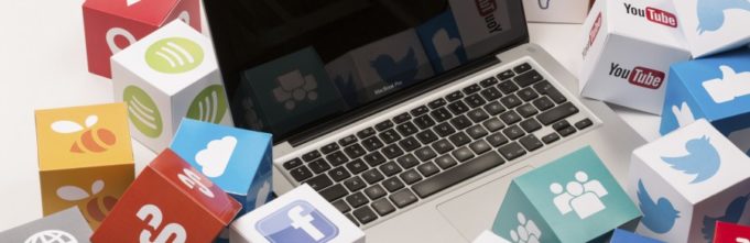 Laptop surrounded by logos from social media