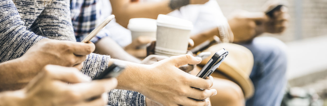 Multicultural friends group using smartphone with coffee at university college break - People hands addicted by mobile smart phone - Technology concept with connected trendy millennials