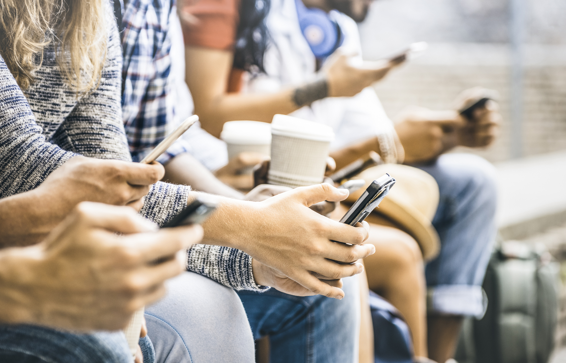 Multicultural friends group using smartphone with coffee at university college break - People hands addicted by mobile smart phone - Technology concept with connected trendy millennials