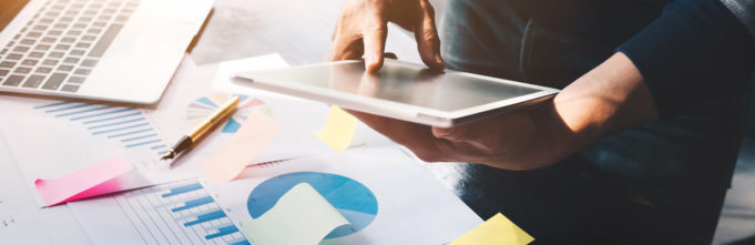 Man reviewing data insights upon a table organized with posit notes.