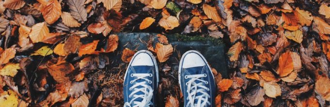 Feet standing in leaves.