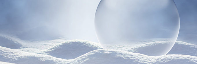 Translucent ball resting on hilly clothlike fabric