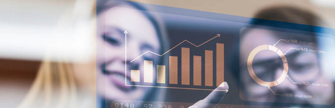Happy employees pointing at a graph