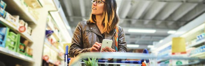 Woman in a grocery store with a shopping cart
