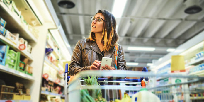 Woman in a grocery store with a shopping cart