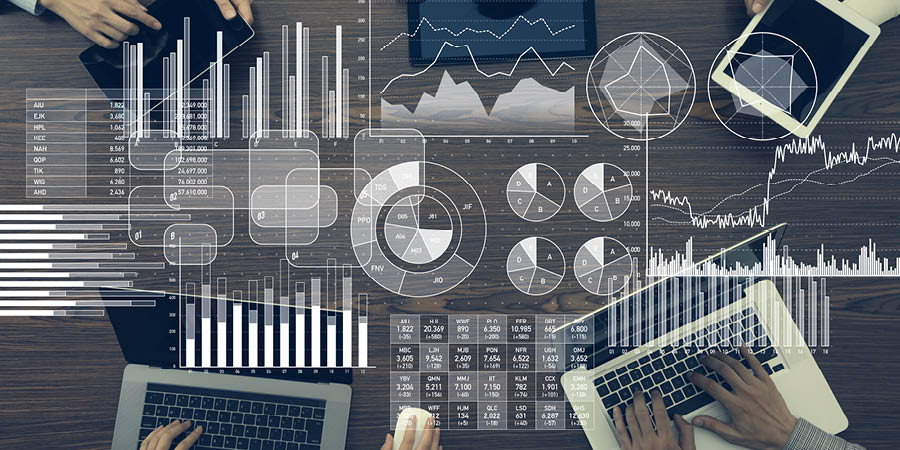 People collaborating with computers with an overlay of a variety of graphs