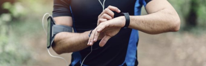 Jogger with athletic outfit on and headphones in his ear