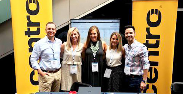 Picture of Basis employees in front of Centro branded step and repeat