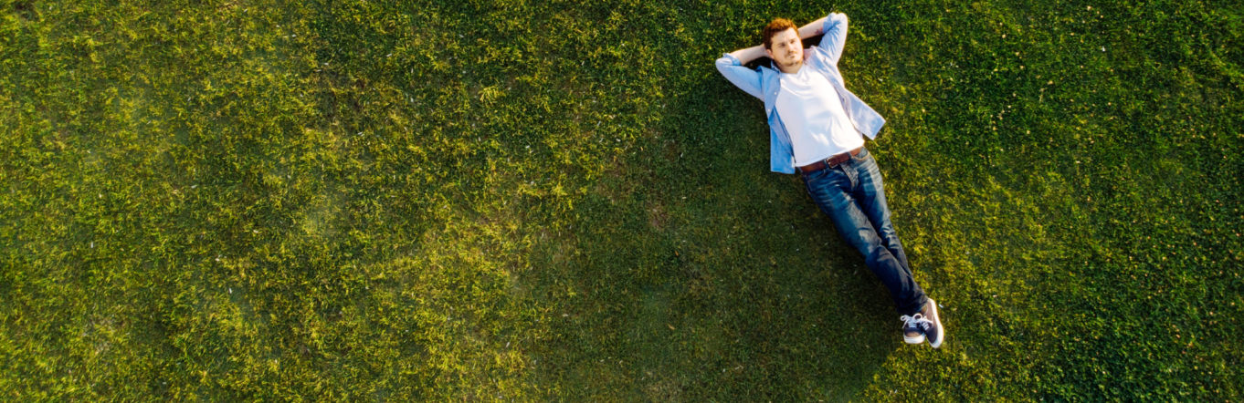 Man relaxes in a field of grass