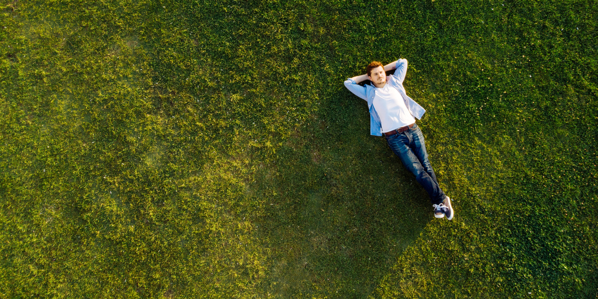 Man relaxes in a field of grass