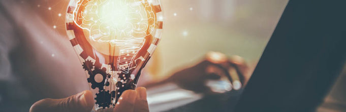 An illuminated bulb that contains a human mind signifying the amalgam of imagination and technology