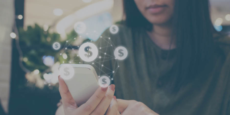 Woman looking at her cellular phone emanating a matrix of dollar signs.