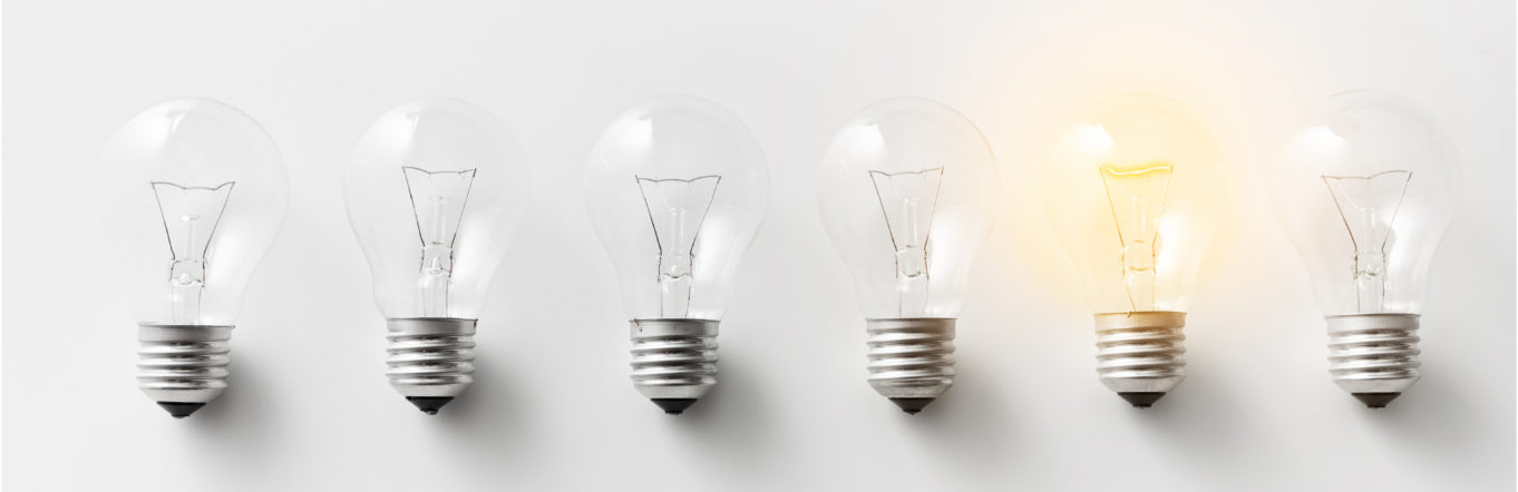 A row of lightbulbs, one of them lit up