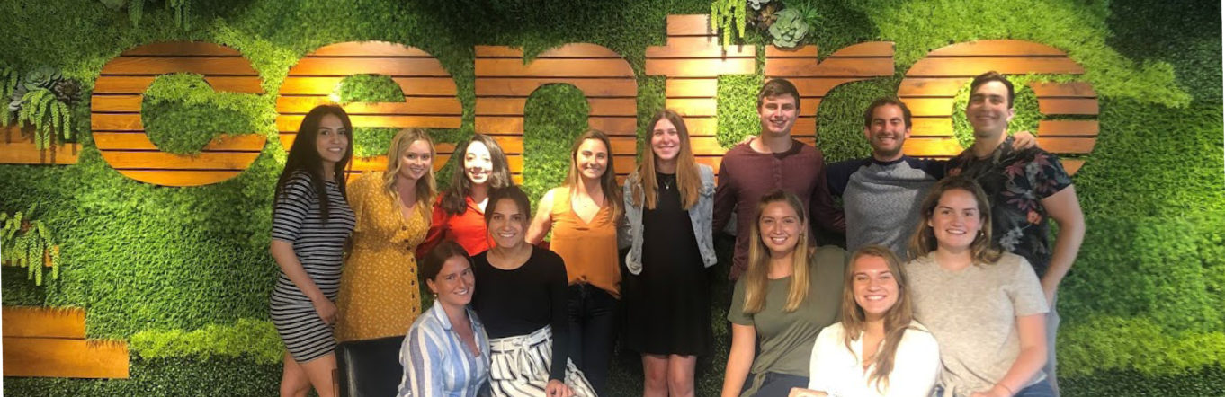 Interns standing in front of a "Centro" sign