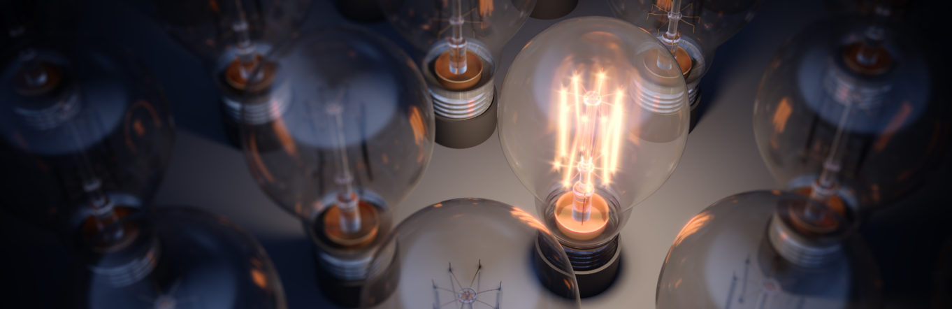 Collection of lightbulbs with one lit up