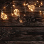 String of festive lights on a wooden background