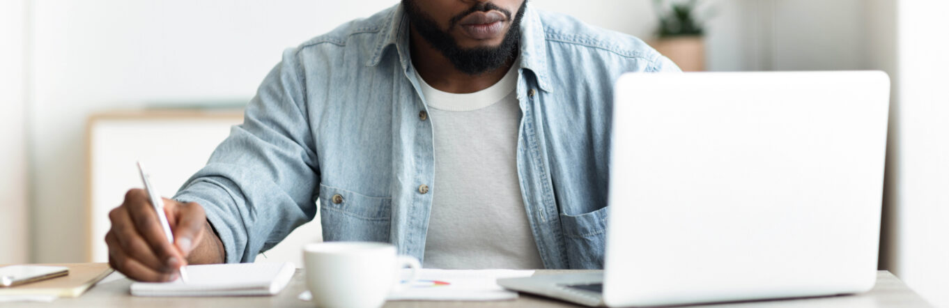 Man looks for a job from his desk