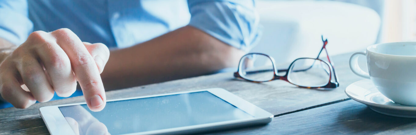 Business man clicking on a tablet