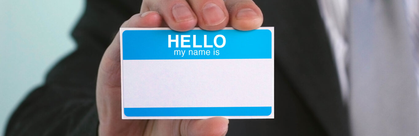 Person holding up a name tag
