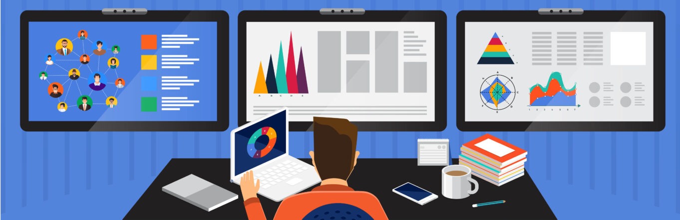 Media planner sits in front of computers with graphs and graphics on them