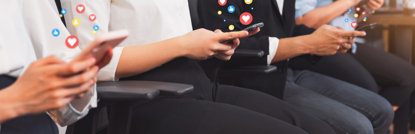 People sitting down and using their phones